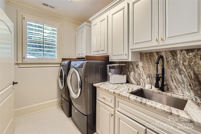 1056 James Madison Dr, Matthews, NC 28104 - washroom featuring cabinet space, washing machine and clothes dryer, light tile patterned flooring, and baseboards