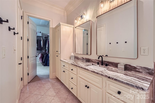 1056 James Madison Dr, Matthews, NC 28104 - bathroom featuring vanity, tile patterned flooring, ornamental molding, and a spacious closet