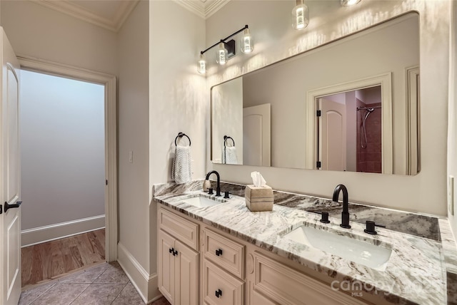 1056 James Madison Dr, Matthews, NC 28104 - bathroom with crown molding, double vanity, tile patterned flooring, and baseboards