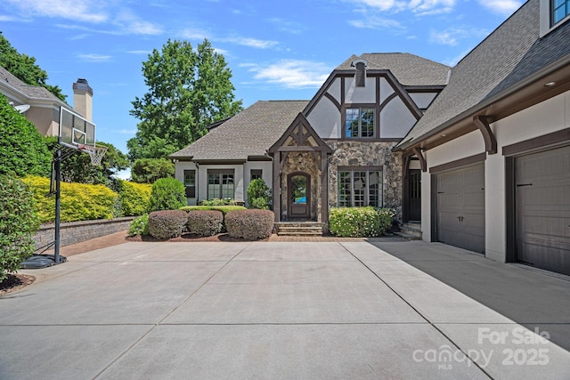 18718 Peninsula Cove Ln, Cornelius, NC 28031 - english style home with stone siding, stucco siding, driveway, and a shingled roof