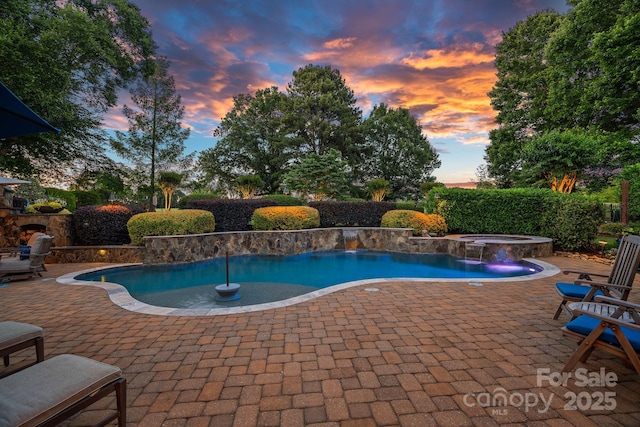 18718 Peninsula Cove Ln, Cornelius, NC 28031 - pool at dusk featuring a patio area and a pool with connected hot tub
