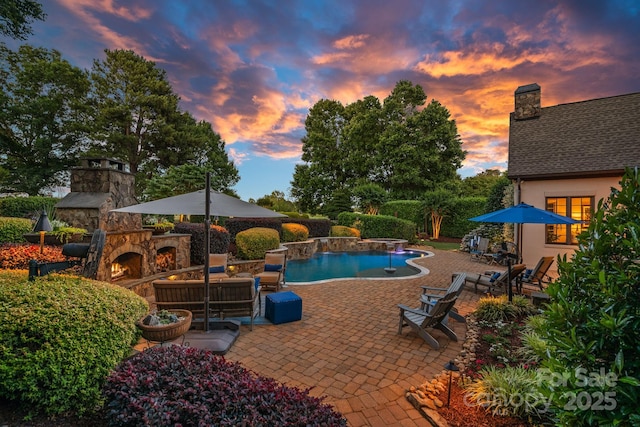 18718 Peninsula Cove Ln, Cornelius, NC 28031 - outdoor pool with an outdoor stone fireplace and a patio area