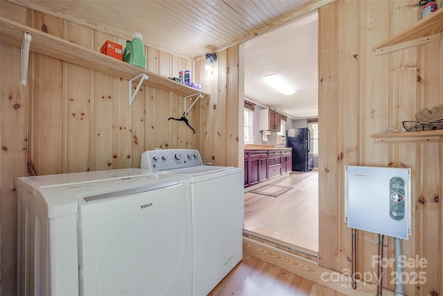 3083 Corinth Rd, Gaffney, SC 29340 - washroom featuring washing machine and clothes dryer, light wood finished floors, and wood walls