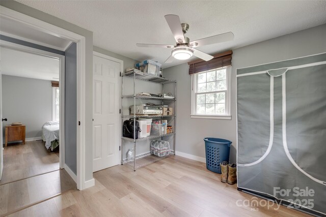 3083 Corinth Rd, Gaffney, SC 29340 - laundry room featuring light wood-type flooring, a ceiling fan, baseboards, and a textured ceiling