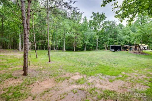 3083 Corinth Rd, Gaffney, SC 29340 - view of grassy yard featuring a wooded view and a carport
