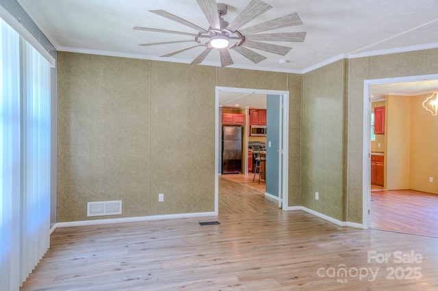 4065 NC-126 Hwy, Morganton, NC 28655 - spare room featuring light wood-type flooring, ceiling fan, a chandelier, ornamental molding, and baseboards