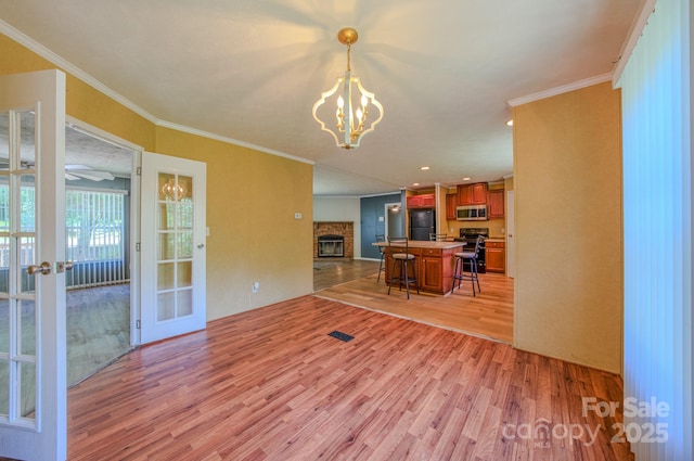 4065 NC-126 Hwy, Morganton, NC 28655 - kitchen with freestanding refrigerator, stainless steel microwave, open floor plan, light wood-type flooring, and stove