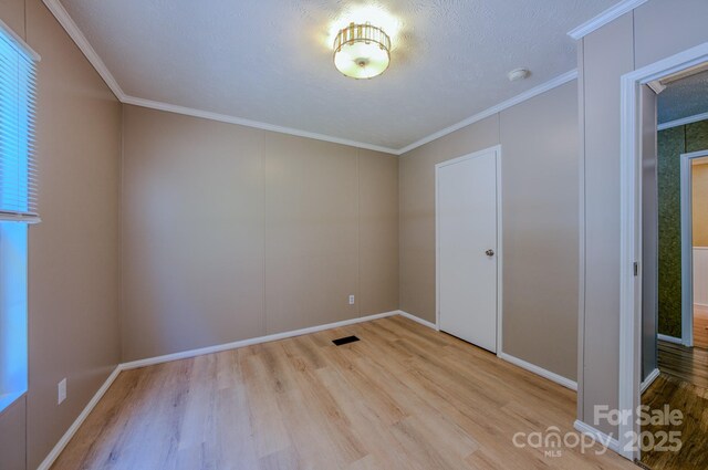 4065 NC-126 Hwy, Morganton, NC 28655 - spare room with wood finished floors, ornamental molding, and baseboards