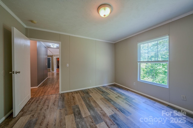 4065 NC-126 Hwy, Morganton, NC 28655 - spare room featuring wood finished floors, crown molding, a smoke detector, and baseboards
