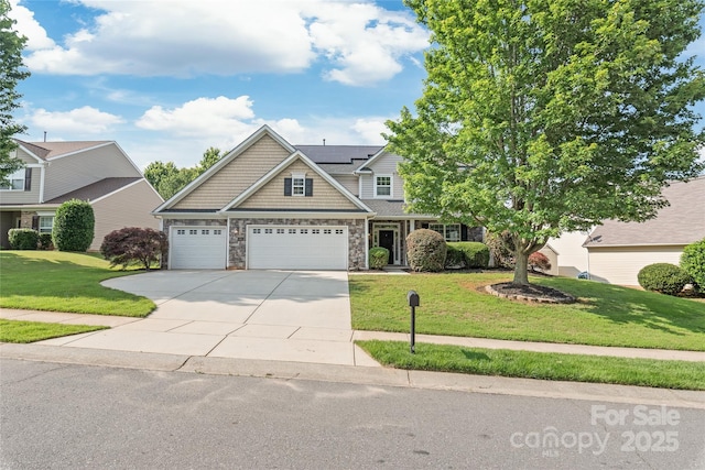 4352 Haddington Dr, Fort Mill, SC 29707 - craftsman-style home with stone siding, driveway, a front yard, roof mounted solar panels, and an attached garage