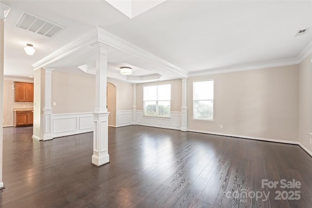 4352 Haddington Dr, Fort Mill, SC 29707 - unfurnished living room featuring decorative columns, dark wood-type flooring, ornamental molding, arched walkways, and wainscoting
