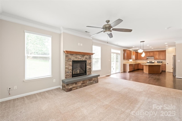 4352 Haddington Dr, Fort Mill, SC 29707 - unfurnished living room featuring dark colored carpet, ornamental molding, baseboards, recessed lighting, and a stone fireplace