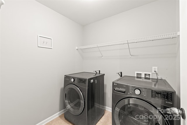 4352 Haddington Dr, Fort Mill, SC 29707 - laundry area featuring washing machine and clothes dryer, baseboards, and light tile patterned flooring
