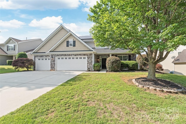 4352 Haddington Dr, Fort Mill, SC 29707 - view of front of house with a garage, a front yard, roof mounted solar panels, driveway, and stone siding