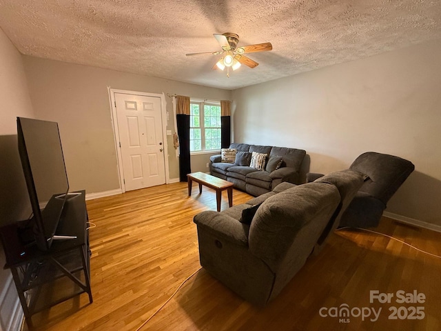 405 Jose St, Shelby, NC 28150 - living area featuring light wood-style floors, a ceiling fan, a textured ceiling, and baseboards