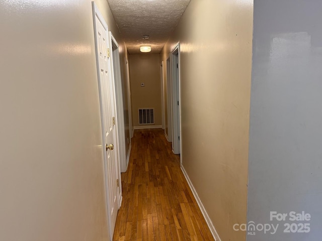 405 Jose St, Shelby, NC 28150 - corridor featuring a textured ceiling, wood finished floors, and baseboards