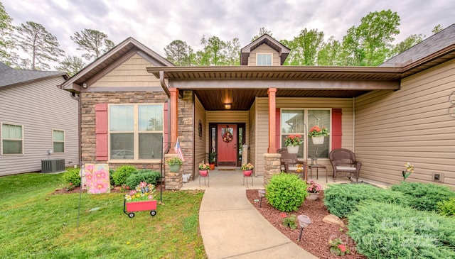 153 Water Leaf Dr, Weaverville, NC 28787 - entrance to property with covered porch, stone siding, a lawn, and central air condition unit