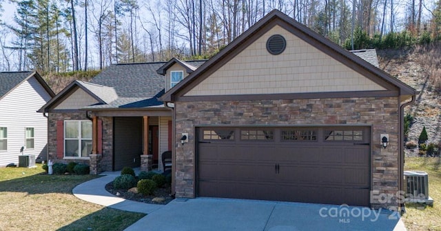 153 Water Leaf Dr, Weaverville, NC 28787 - craftsman house featuring stone siding, a garage, and driveway