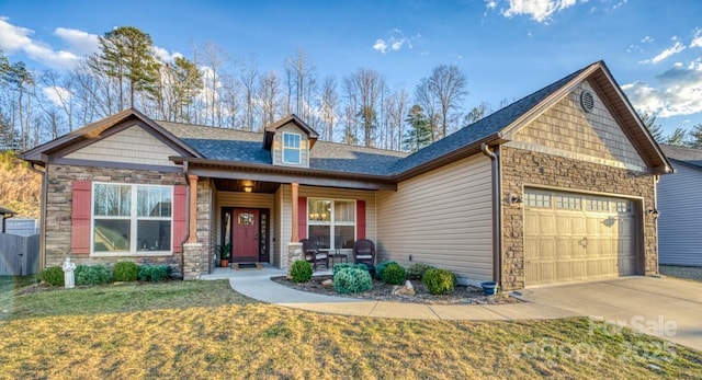 153 Water Leaf Dr, Weaverville, NC 28787 - craftsman-style house with stone siding, a porch, a front yard, a shingled roof, and an attached garage