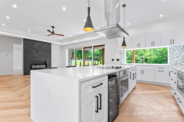 3078 Mountain Creek Dr, Sherrills Ford, NC 28673 - kitchen featuring island range hood, recessed lighting, a fireplace, beverage cooler, and a kitchen island