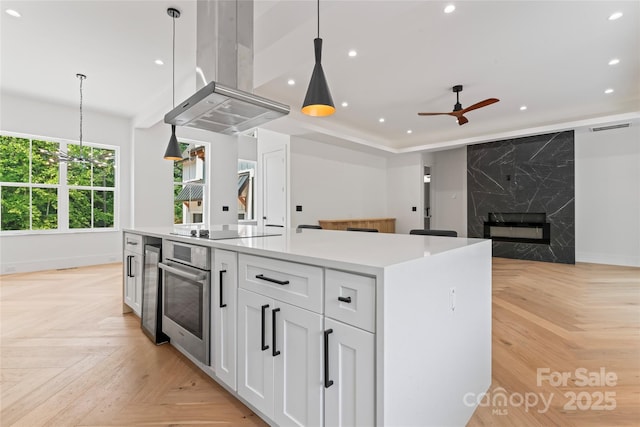3078 Mountain Creek Dr, Sherrills Ford, NC 28673 - kitchen featuring stainless steel oven, island range hood, black electric cooktop, baseboards, and recessed lighting
