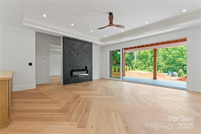 3078 Mountain Creek Dr, Sherrills Ford, NC 28673 - unfurnished living room with a raised ceiling, baseboards, plenty of natural light, recessed lighting, and a ceiling fan