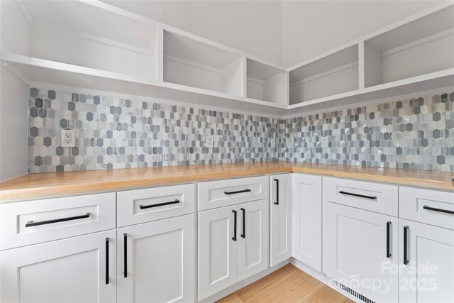 3078 Mountain Creek Dr, Sherrills Ford, NC 28673 - kitchen featuring open shelves, backsplash, white cabinetry, and light wood-style flooring