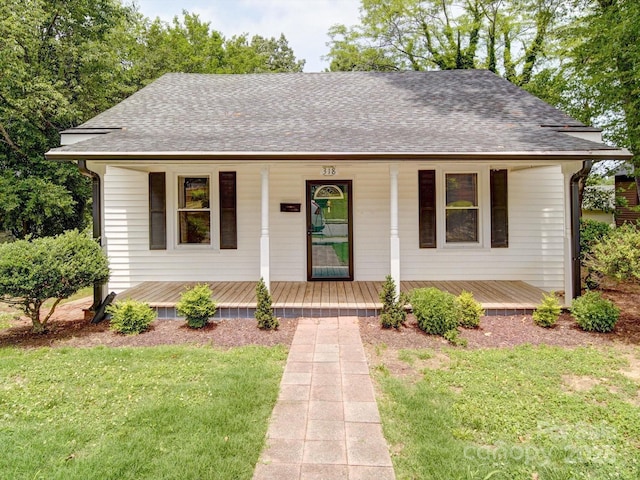 318 Chestnut Ave, Kannapolis, NC 28081 - view of front of home featuring a porch, a front lawn, and a shingled roof