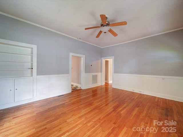 318 Chestnut Ave, Kannapolis, NC 28081 - spare room with wood finished floors, wainscoting, ceiling fan, and ornamental molding