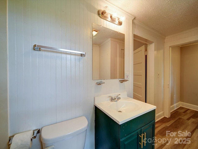318 Chestnut Ave, Kannapolis, NC 28081 - half bath with wood finished floors, toilet, vanity, a textured ceiling, and baseboards