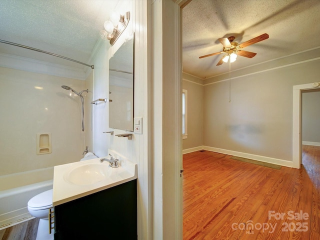318 Chestnut Ave, Kannapolis, NC 28081 - full bath with a textured ceiling, crown molding, a ceiling fan, wood finished floors, and toilet