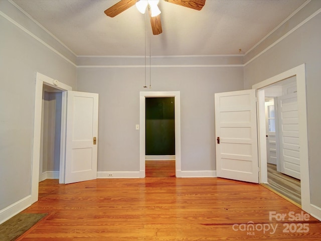 318 Chestnut Ave, Kannapolis, NC 28081 - unfurnished bedroom with ornamental molding, light wood-type flooring, baseboards, and a ceiling fan