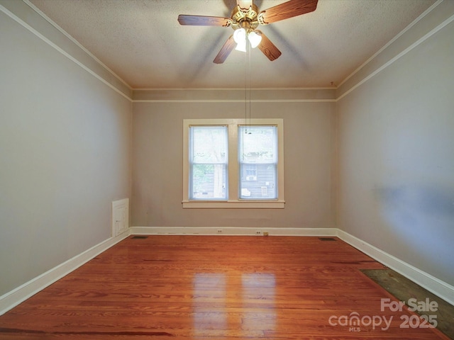 318 Chestnut Ave, Kannapolis, NC 28081 - spare room with a textured ceiling, crown molding, wood finished floors, baseboards, and a ceiling fan