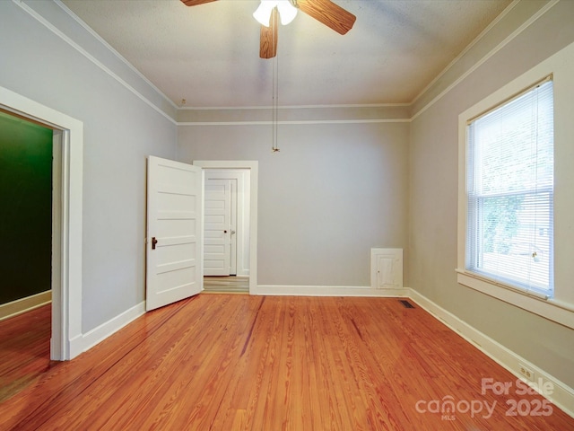 318 Chestnut Ave, Kannapolis, NC 28081 - spare room featuring crown molding, a ceiling fan, light wood-type flooring, and baseboards