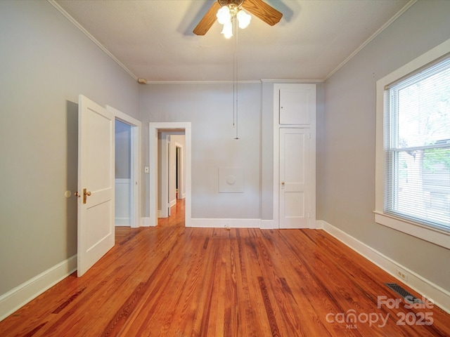 318 Chestnut Ave, Kannapolis, NC 28081 - empty room with crown molding, ceiling fan, wood finished floors, and baseboards