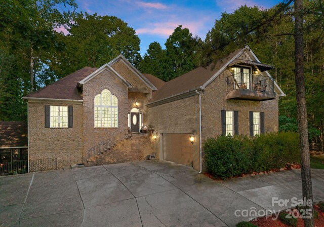 171 Secretariat Dr, Mooresville, NC 28117 - view of front of property with a balcony, driveway, and brick siding