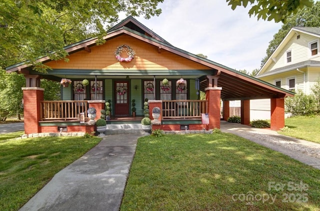 401 7th St, Spencer, NC 28159 - view of front of home featuring covered porch, a front yard, asphalt driveway, and a carport