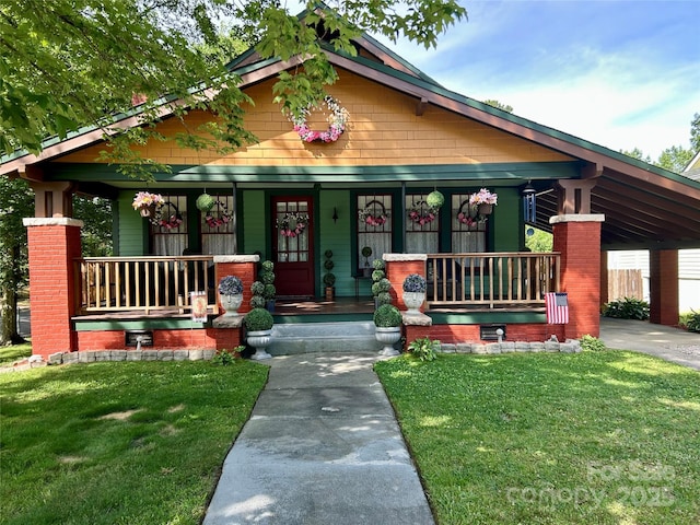 401 7th St, Spencer, NC 28159 - view of front of home with covered porch, a front yard, and a carport