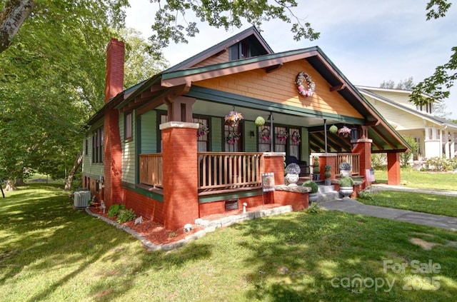 401 7th St, Spencer, NC 28159 - view of front of property featuring a chimney, a porch, a front lawn, and central AC unit