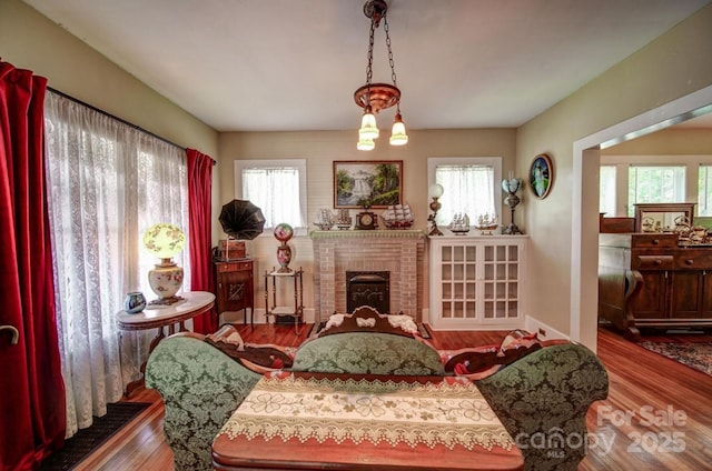 401 7th St, Spencer, NC 28159 - living area featuring wood finished floors, plenty of natural light, and a fireplace