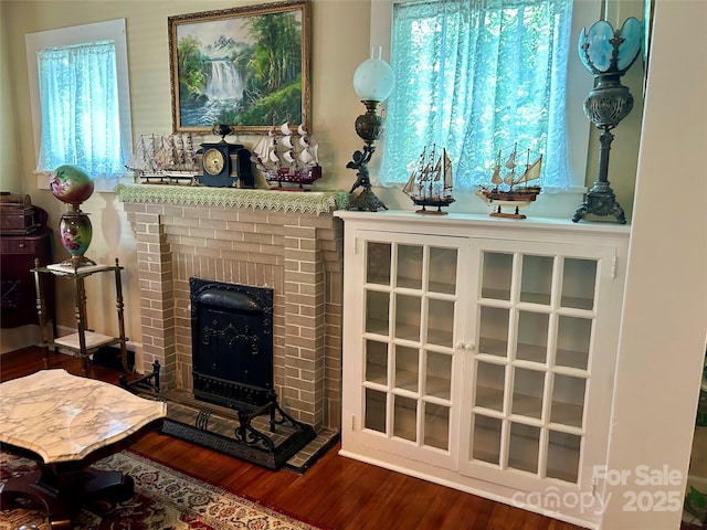 401 7th St, Spencer, NC 28159 - living room with wood finished floors, plenty of natural light, and a brick fireplace