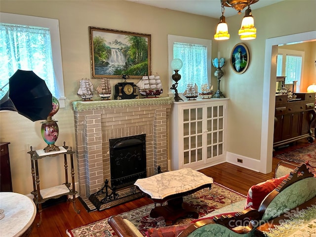 401 7th St, Spencer, NC 28159 - living area featuring wood finished floors, plenty of natural light, a fireplace, and baseboards