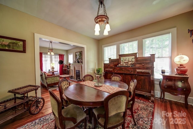 401 7th St, Spencer, NC 28159 - dining area featuring plenty of natural light, dark wood-type flooring, and a fireplace