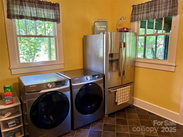 401 7th St, Spencer, NC 28159 - laundry room featuring washer and dryer, dark tile patterned flooring, and baseboards