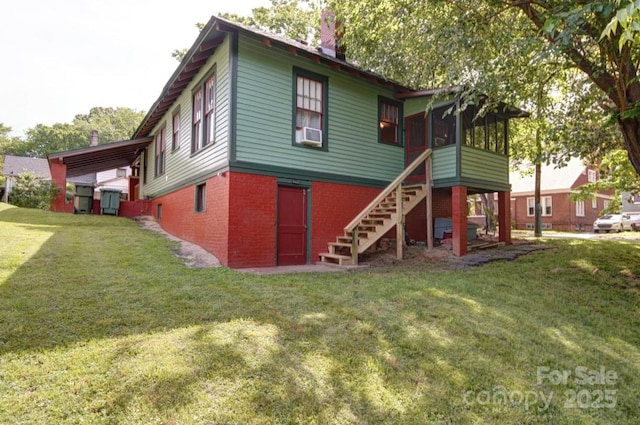 401 7th St, Spencer, NC 28159 - rear view of property with brick siding, stairway, a chimney, a yard, and a sunroom