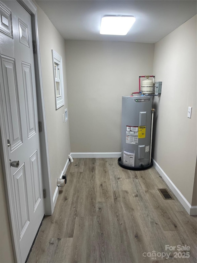 utility room featuring electric water heater