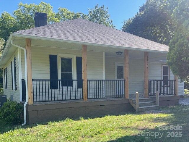 1327 Wiscassett St, Albemarle, NC 28001 - back of house with a chimney, a porch, and a shingled roof