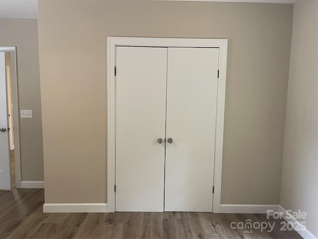 1327 Wiscassett St, Albemarle, NC 28001 - unfurnished bedroom with wood finished floors, baseboards, and a closet