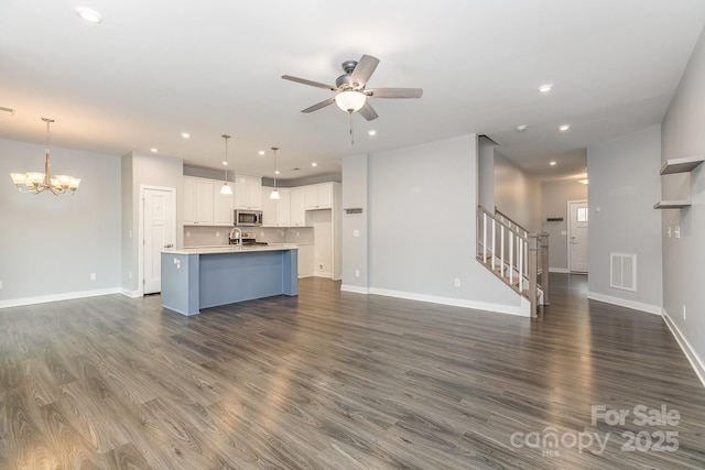 138 Lanyard Dr Unit B, Mooresville, NC 28117 - unfurnished living room featuring stairway, a chandelier, a ceiling fan, dark wood-style floors, and recessed lighting