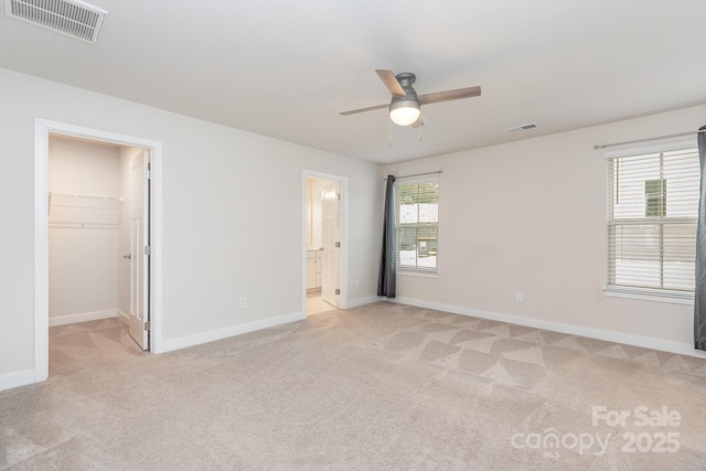 138 Lanyard Dr Unit B, Mooresville, NC 28117 - unfurnished bedroom with light colored carpet, baseboards, a walk in closet, ceiling fan, and ensuite bathroom